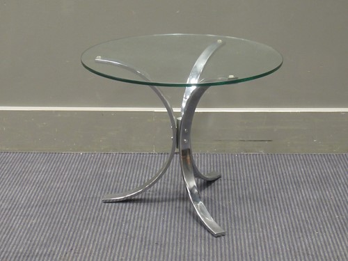 Lot 561 - A chrome occasional table with circular glass...