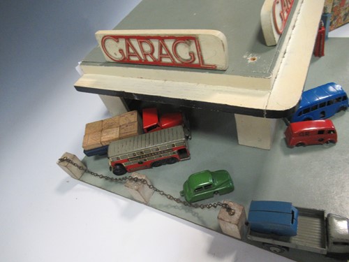 Lot 102 - A model toy garage, probably 1950s, with...