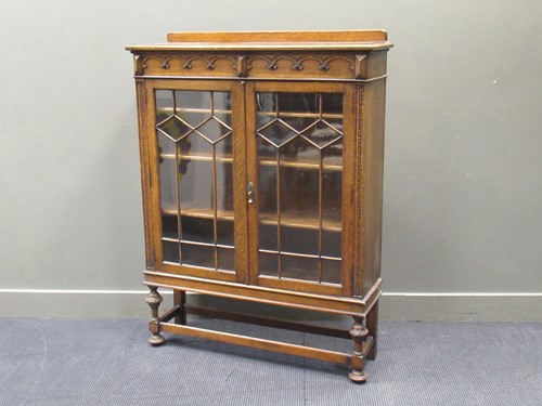 Lot 475 - A 1940s glazed oak bookcase, 140 x 107 x 32cm