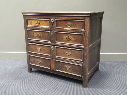 Lot 500 - An 18th century oak chest of two short and...