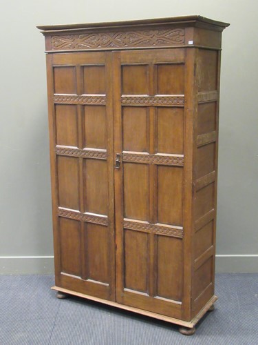 Lot 565 - An oak wardrobe with panelled doors, 184 x 110...