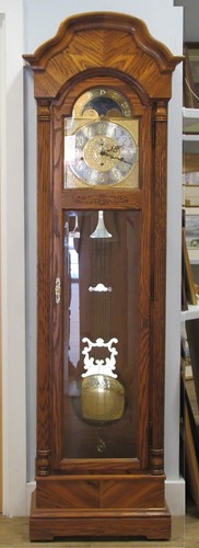 Lot 194 - A modern Howard Miller oak cased longcase clock