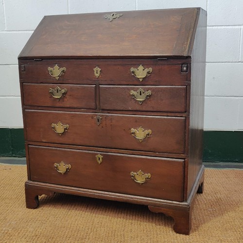 Lot 542 - An 18th century oak bureau, the fall front...