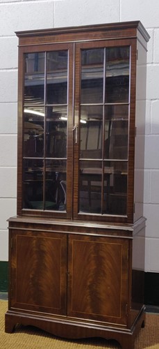 Lot 481 - An Edwardian mahogany glazed cabinet rasied on...