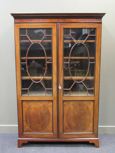 Lot 524 - A Regency mahogany bookcase, the dental...