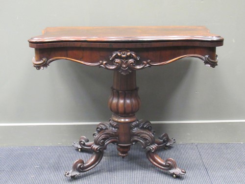 Lot 465 - A Victorian rosewood card table, the fold-over...