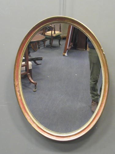 Lot 558 - A 19th century oval giltwood mirror, 82.5 x 61....