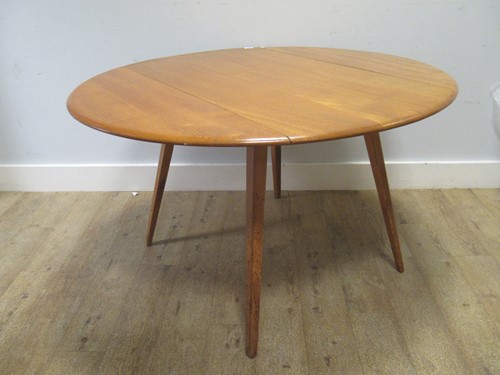 Lot 573 - Ercol mid century drop leaf table. 71 x 113 x...