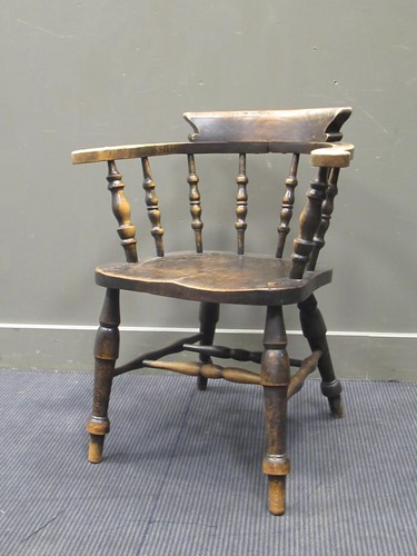 Lot 567 - An early 20th century smokers bow armchair...