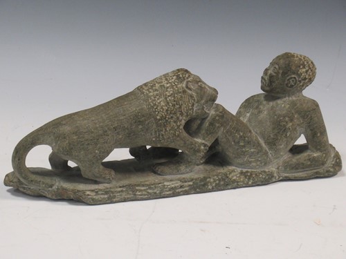 Lot 63 - Carved stone sculpture of a boy with a lion,...