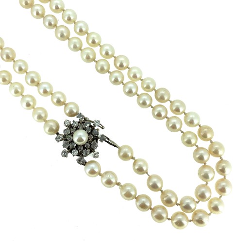 Lot 154 - A double row pearl necklace with a fancy clasp
