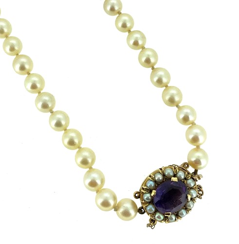 Lot 101 - A single row of pearls with an amethyst clasp