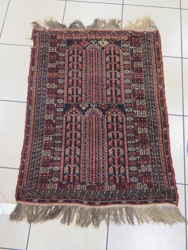 Lot 618 - A blue ground rug of tribal design 145 x 94cm