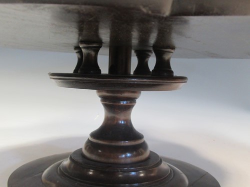 Lot 582 - A mahogany revolving lazy susan, 18cm high and...