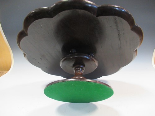 Lot 582 - A mahogany revolving lazy susan, 18cm high and...