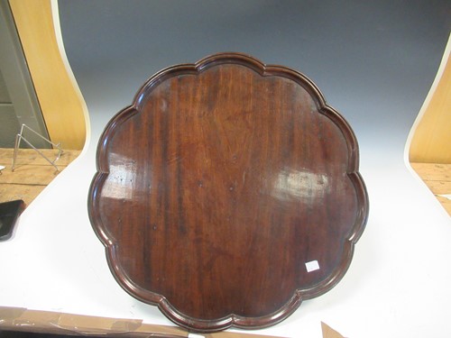 Lot 582 - A mahogany revolving lazy susan, 18cm high and...