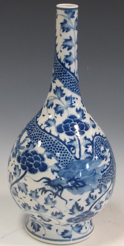Lot 37 - A blue and white vase decorated with a dragon...