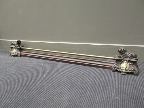 Lot 538 - A brass fender, the supports cast as two...