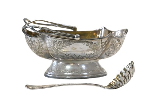 Lot 580 - A Victorian silver sugar basket and accompanying sifting spoon