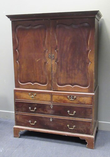 Lot 418 - A George III mahogany linen press, the shaped...