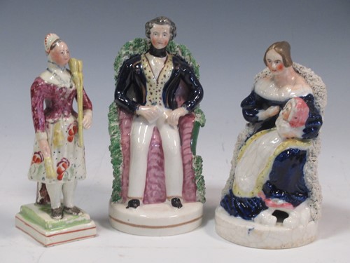 Lot 8 - A Staffordshire figure of Queen Victoria and...