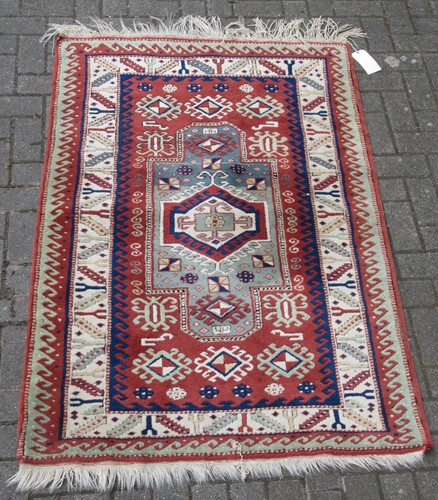 Lot 619 - A Heriz type red ground rug with geometric...