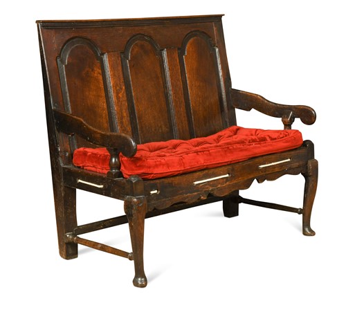 Lot 121 - A George III oak three panel settle