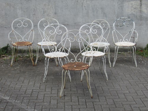 Lot 590 - A set of seven white painted garden chairs (7)