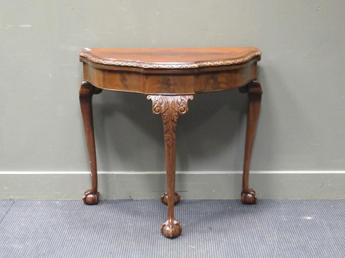 Lot 458 - A Georgian style walnut card table by Maple &...