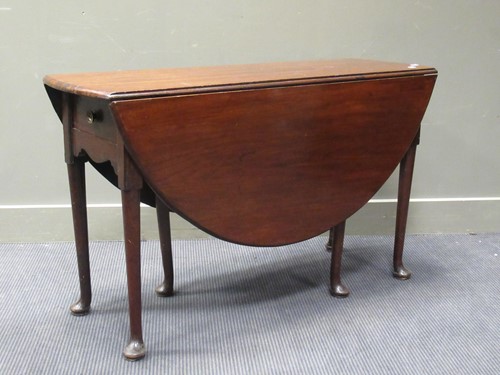 Lot 478 - A mahogany drop leaf table on pad feet with...