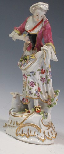 Lot 51 - A German porcelain model of a woman with...