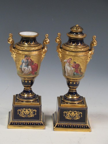 Lot 10 - A pair of Vienna gilt decorated porcelain urns,...