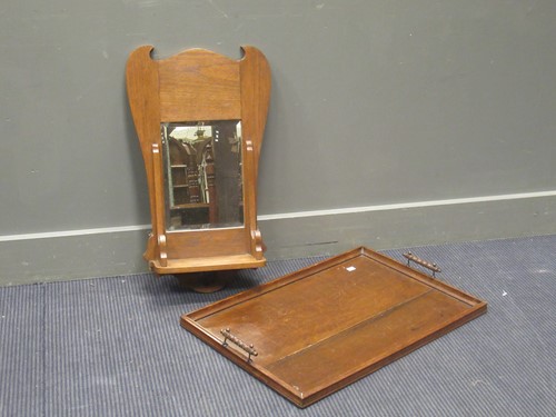 Lot 530 - An Arts & Crafts oak wall mirror with shelf...