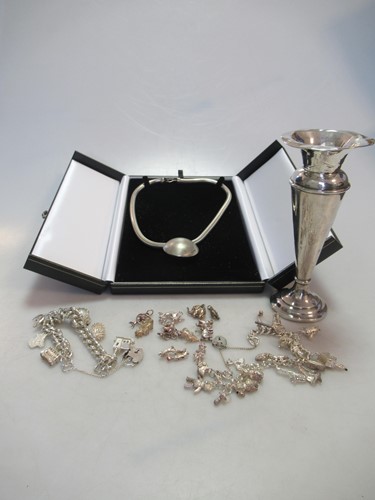 Lot 241 - A silver necklace, together with a charm...