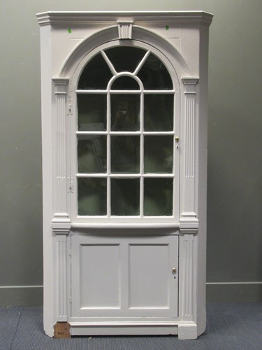 Lot 428 - A white painted corner cupboard, the moulded...