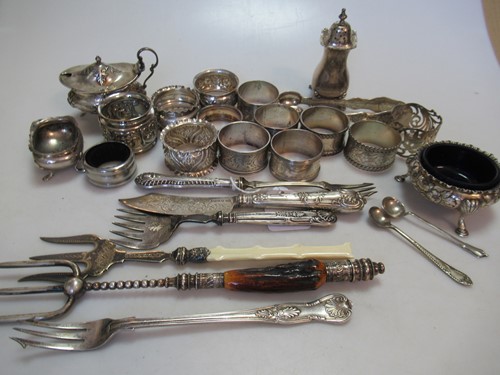 Lot 183 - An assortment of silver, mainly napkin rings,...
