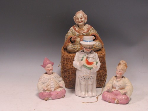 Lot 39 - A group of four bisque nodding head figures,...