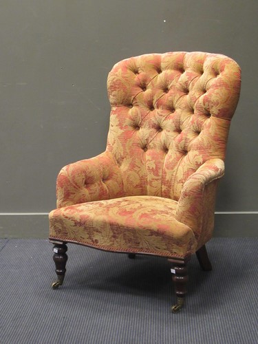 Lot 442 - A button-back armchair on turned front legs...