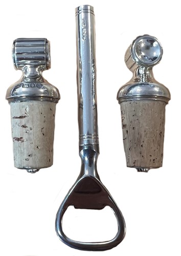Lot 428 - A pair of 20th century silver topped bottle stoppers together with a silver handled bottle opener