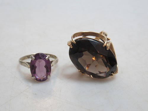 Lot 163 - A smoky quartz ring together with an amethyst...