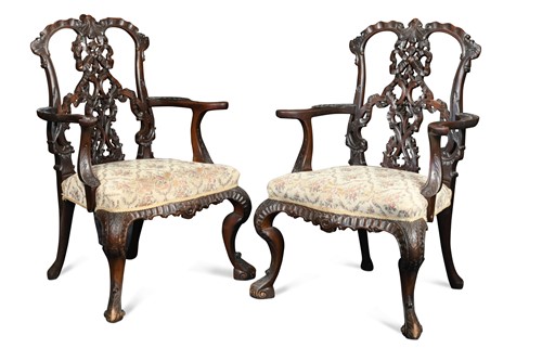Lot 200 - A pair of Chippendale style mahogany ribbon backed elbow chairs, 20th century