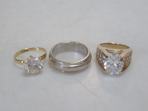 Lot 172 - A cubic zirconia dress ring stamped '14K', and...
