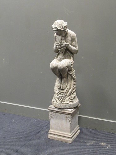 Lot 480 - A composite stone garden statue of Bacchus, on...