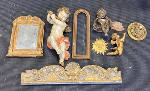 Lot 84 - A painted wooden model of a cherub, 56cm long,...