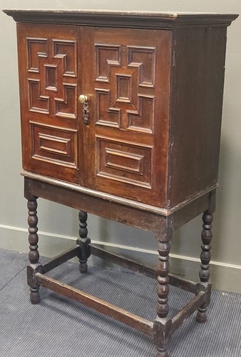 Lot 404 - An 18th century and later oak panelled cabinet...