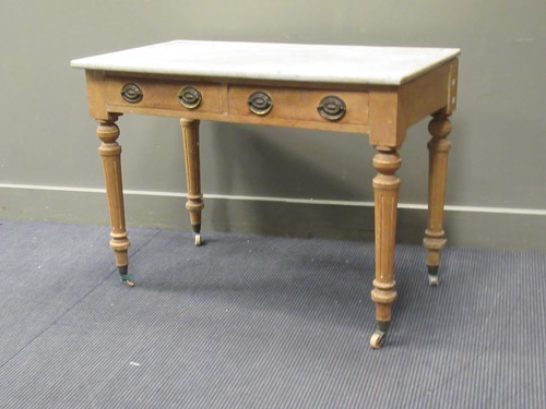 Lot 332 - A pine two drawer side table with marble top,...