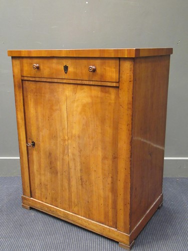 Lot 325 - A Biedermeier pedestal cupboard with one long...