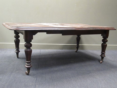 Lot 458 - A Victorian mahogany dining table, the rounded...