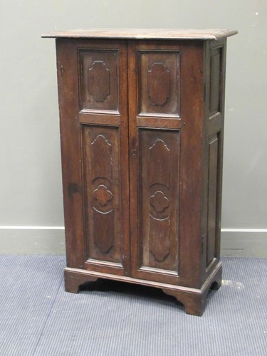 Lot 423 - An oak cupboard in the antique style enclosed...
