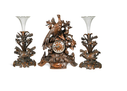 Lot 339 - A Swiss Black Forest clock garniture, 19th century